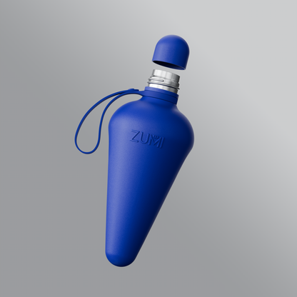 A Blue stainless steel reusable water bottle with a loop on the lid, branded with 'ZUMI'.