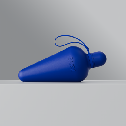 A Blue stainless steel reusable water bottle with a loop on the lid, branded with 'ZUMI'.